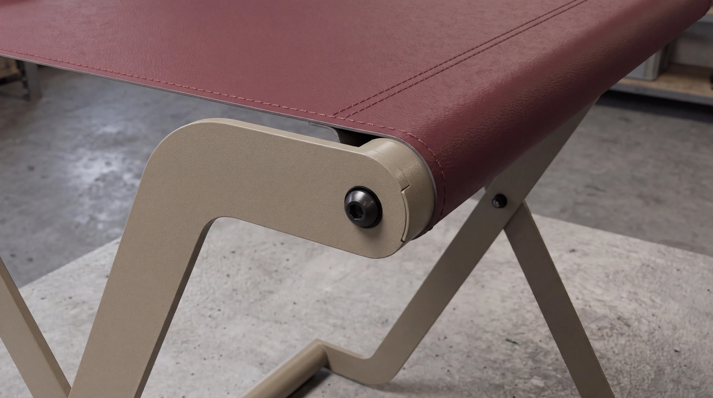 Il fianco di un portavaligie: struttura di metallo chiaro e piano con rivestimento bordeaux cucito